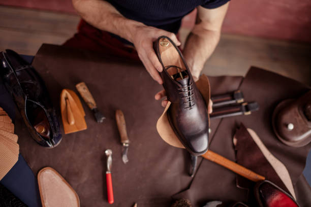 istock beautiful repaired shoes in man's hands 1242893908