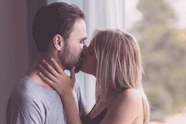 istock A woman kissing a man. 1242896127