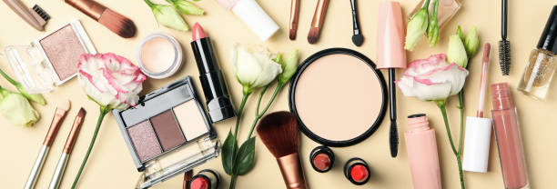 istock Different makeup cosmetics and flowers on beige background. Female accessories 1242898324