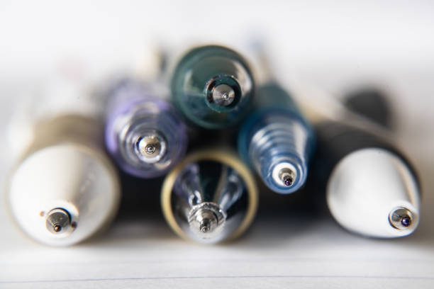 Horizontal photograph of a black and brown coloured ballpoint pen over a white background.