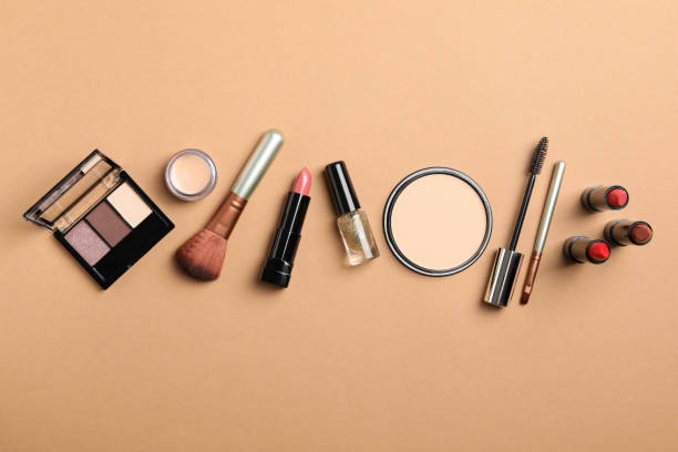 istock Different makeup cosmetics on brown background. Female accessories 1242909240