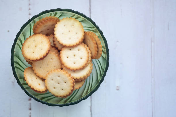 istock Crackers with pineapple jam in green glass bowl on wood table 1242924772