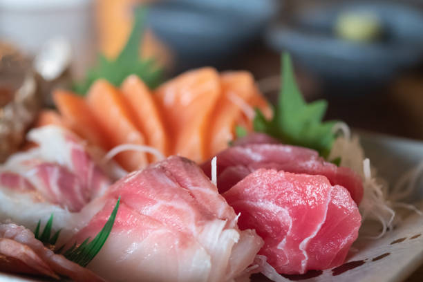 istock Selective focus of mixed slices of fresh raw salmon sashimi for dinner. Assorted fresh sashimi and Japanese food concept. 1242925747