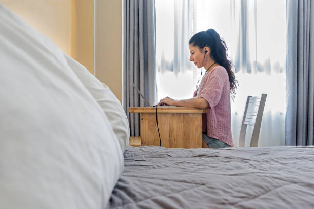 istock Woman with laptop at home workspace. 1242928988