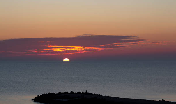 istock Under the attractive clouds, the sun rises 1242941653