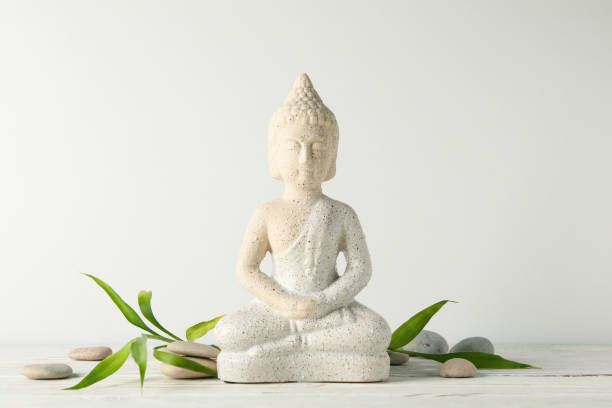 istock Buddha and stones on wooden table. Zen concept 1242948634