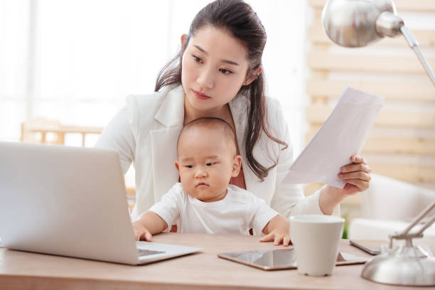 istock Young mother holding the children work at home 1242963484