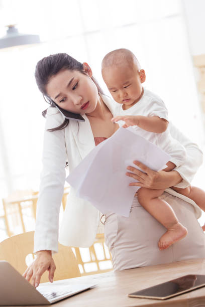 istock Young mother holding the children work at home 1242963679