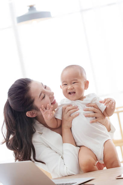 istock Young mother holding the children work at home 1242963808