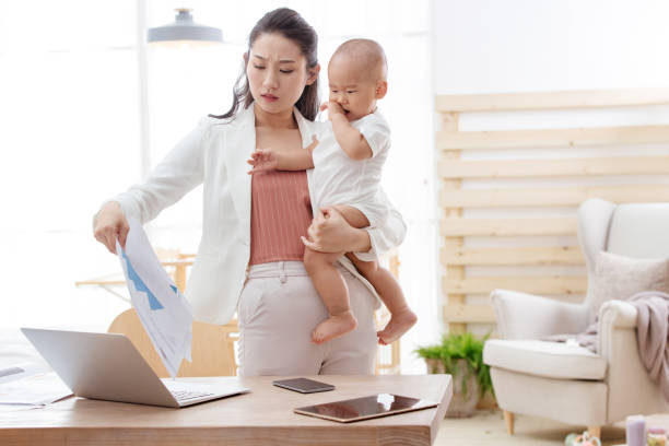 istock Young mother holding the children work at home 1242963810