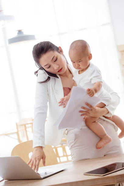 istock Young mother holding the children work at home 1242964413