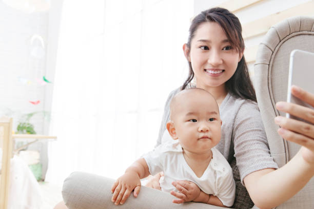istock A young mother and baby with a cell phone camera 1242964437