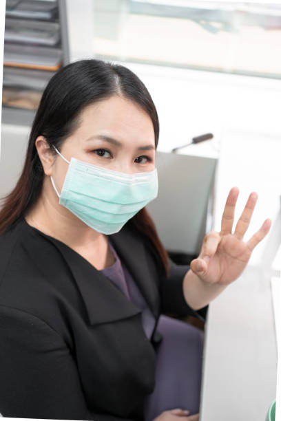 istock Wearing a mask in the office to prevent coronavirus 1242973468