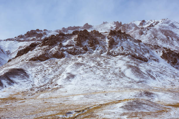 istock lanscape with barren mountain which is covered with ice 1242973996