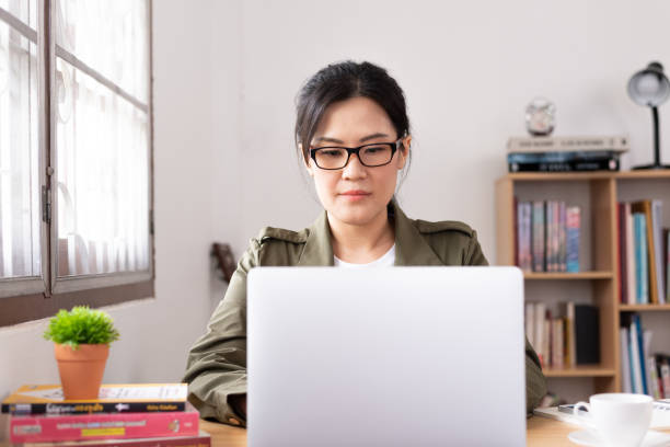 istock Modern young Asian woman working from home. 1242997891