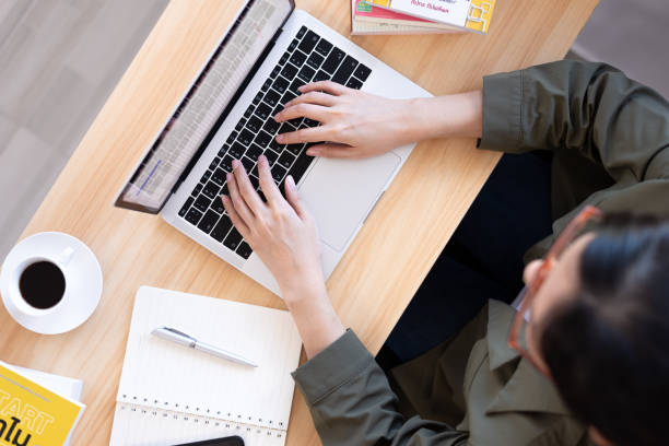 istock Modern young Asian woman working from home with top view. 1242998082