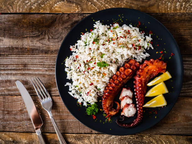 istock Fried octopus with white rice on wooden table 1243000221
