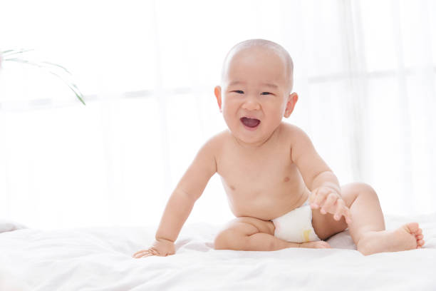 istock Play happy baby sitting on the bed 1243005330