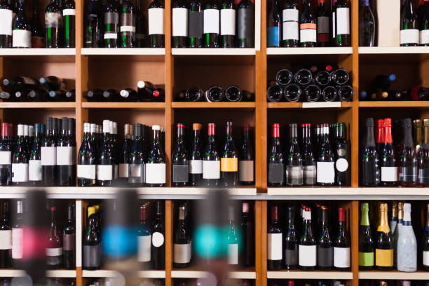 istock Racks with red and white wine bottles in market 1243013960