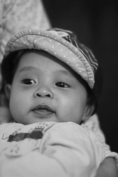 istock A lovely baby boy wears a cap with happy smiling 1243014539