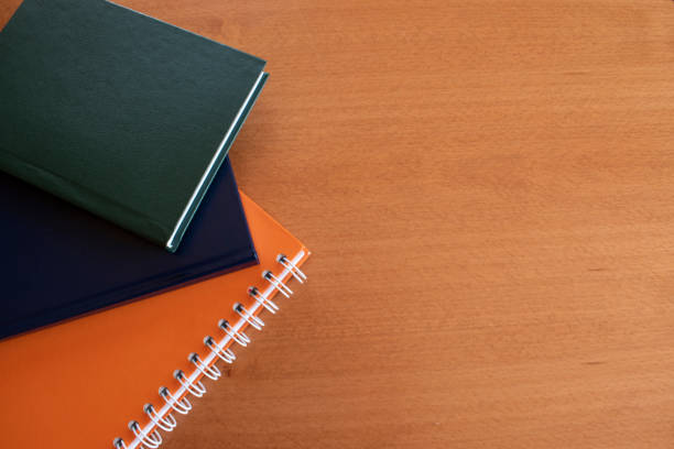 istock Colorful books/ notebooks  on wooden background. Copy space 1243023826