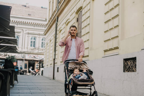 istock Father walking with a baby boy in baby stroller 1243036375