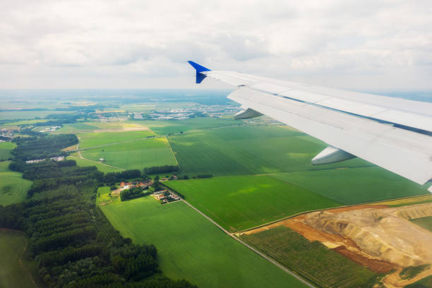 istock Airplane flying above the fields in Europe 1243045546