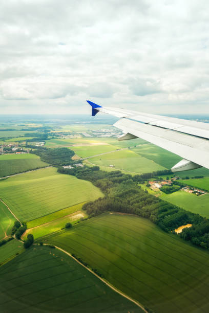 istock Airplane flying above the fields in Europe 1243045560