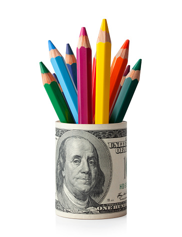 Roll of dollar banknotes with colored pencils isolated on white background.