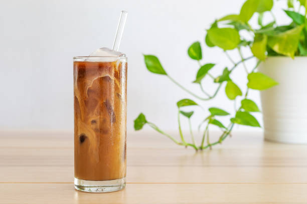 istock cold brew coffee with milk on white wooden table. 1243049382