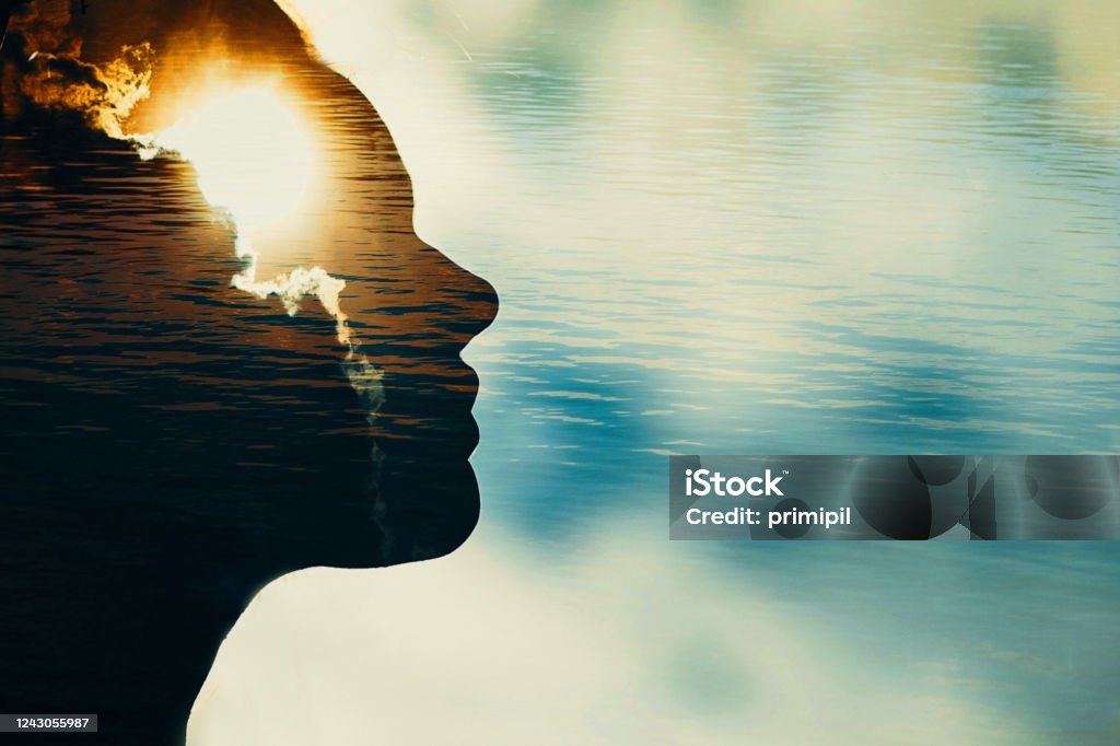 Woman silhouette with sun in head with copy space. Multiple exposure image. Contemplation Stock Photo