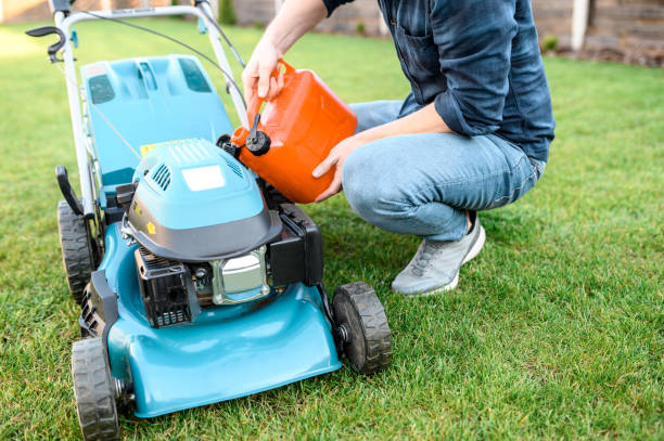 istock Young guy in casual clothes refills a gas mower 1243060969