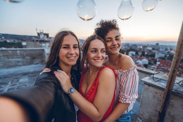 istock Three young women making selfie on rooftop 1243066078