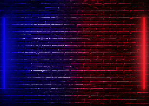istock Empty studio dark room black brick wall with blue and red neon lighting effect. 1243068920