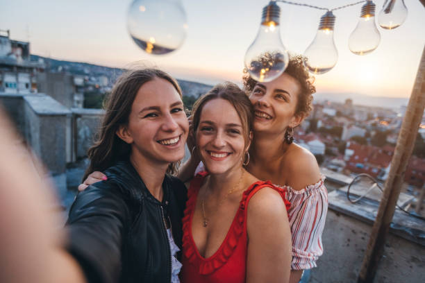istock Three young women making selfie on rooftop 1243069473