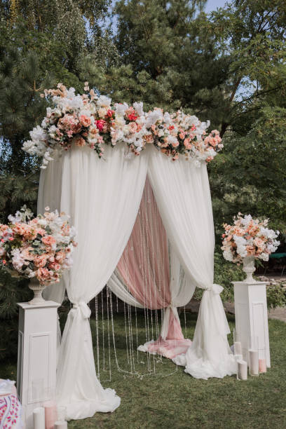 istock arch for a wedding ceremony with flowers in park 1243072332