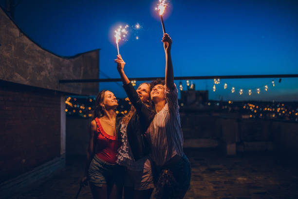 istock Rooftop party friends with sparklers 1243072876