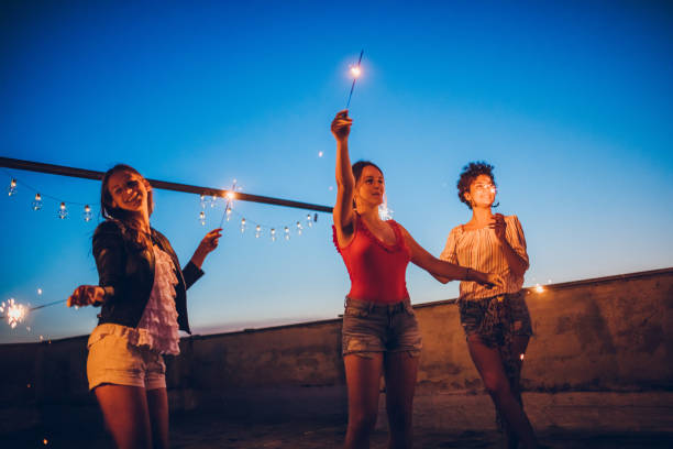 istock Rooftop party friends with sparklers 1243075068