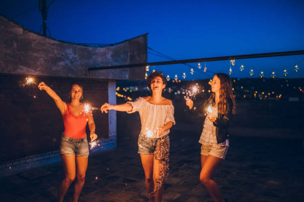 istock Rooftop party friends with sparklers 1243075633
