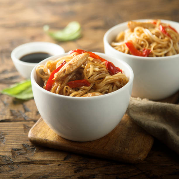 istock Fried rice noodles with chicken 1243076181