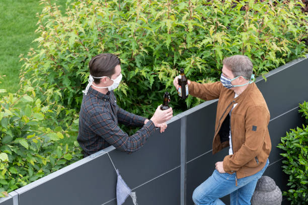 Men drinking beer Corona distance neighbors Cheers life stile stock pictures, royalty-free photos & images