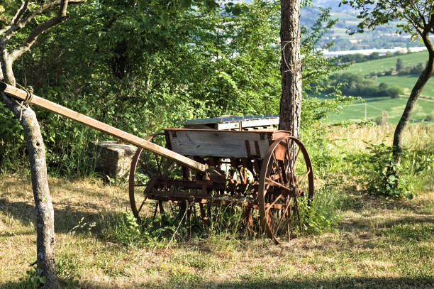 A rusty plow in the countryside fields near a farm (Pesaro, Italy, Europe)