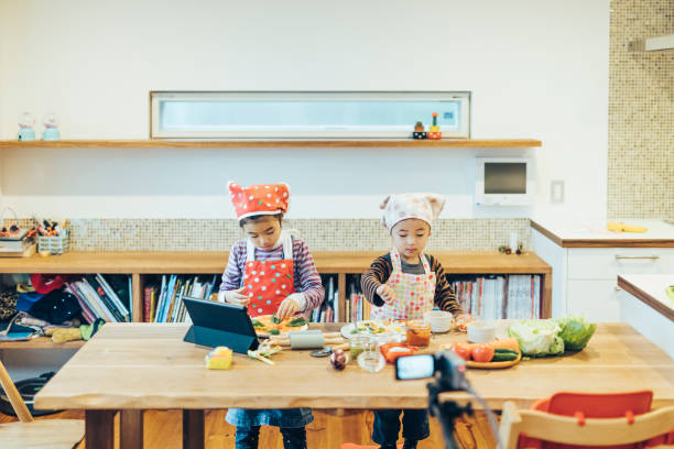 istock Children watching cooking instructions from the internet. 1243082506