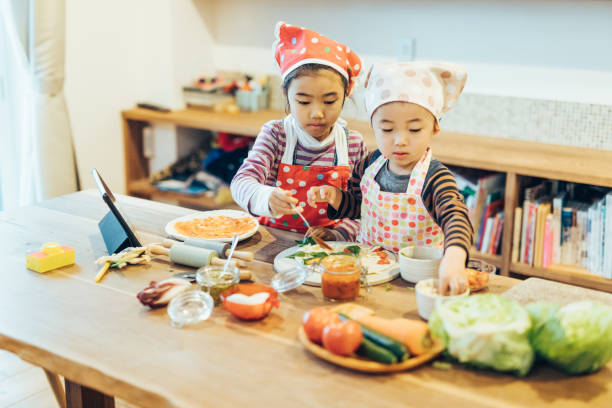 istock Brother and Sister Cooking Together 1243082546