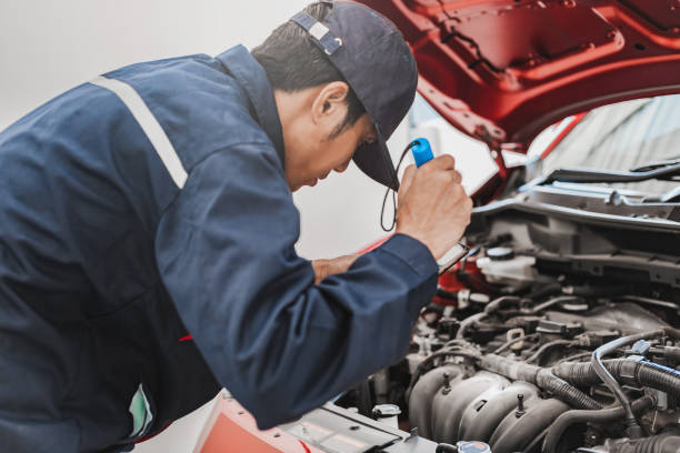 istock Asian Man mechanic inspection Shine a torch car engine checking bug in engine.Blue car for service maintenance insurance with car engine.for transport automobile automotive 1243093527