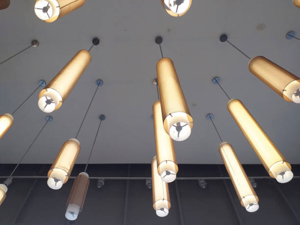 istock Creative cylinder ceiling lamp.Ceiling with pendant lamps, long light tube. Interior design detail. Modern industrial style decoration. 1243097369