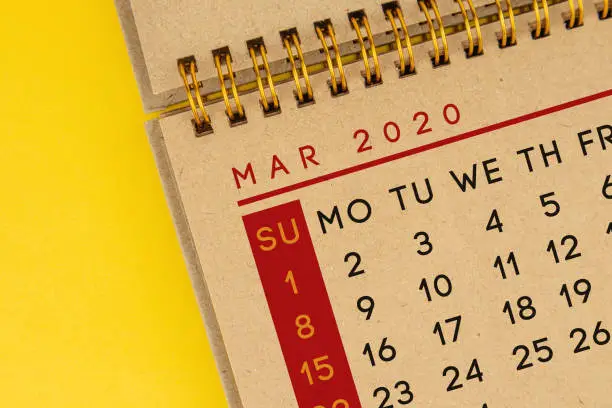 Kraft March calendar is on yellow background. Horizontal composition with copy space. Calendar Concept.
