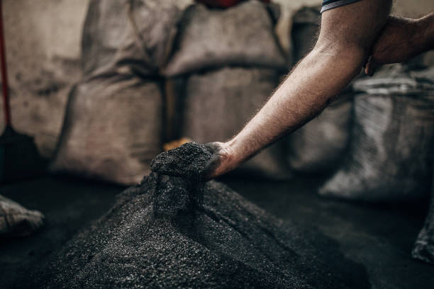 istock Close view of man picking up coal 1243128335