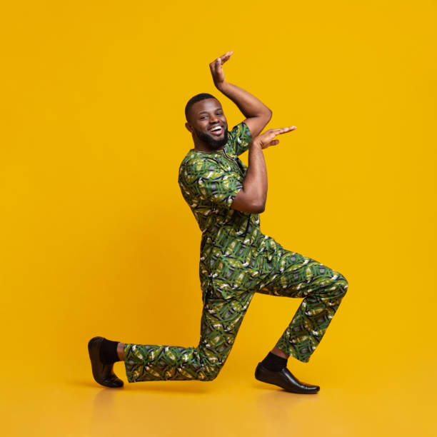 istock Funny black guy fooling over yellow background 1243134876