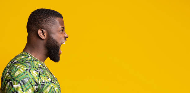 istock Side view of angry black guy shouting towards copy space 1243135975
